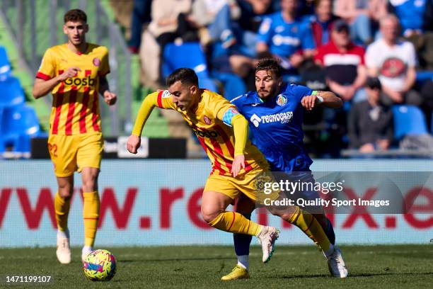 Portu of Getafe CF battle for the ball with Borja Garcia of Girona FC during the LaLiga Santander match between Getafe CF and Girona FC at Coliseum...