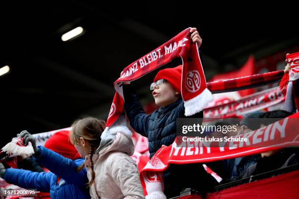 Mainz 05 fans hold up scarfs prior to the Bundesliga match between 1. FSV Mainz 05 and TSG Hoffenheim at MEWA Arena on March 04, 2023 in Mainz,...