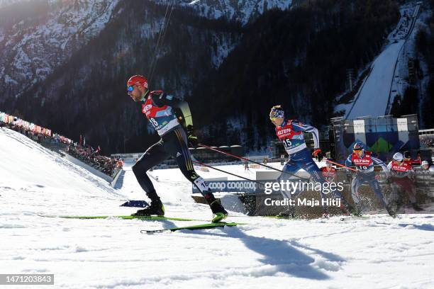 Johannes Rydzek of Germany and Eero Hirvonen of Finland compete during the cross country leg of Nordic Combined Men's Gundersen Large Hill HS138/10km...