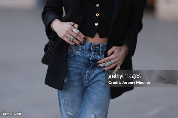 Marina Theodoridou seen wearing black oversized jacket Alaia, black vest with gold buttons Schiaparelli, blue high waist jeans Rt13, eye-catching...