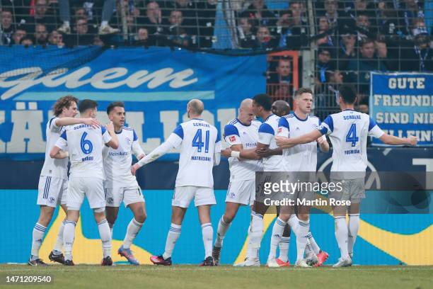 Players of FC Schalke 04 celebrate their first goal after Manuel Riemann of VfL Bochum 1848 scores an own goal during the Bundesliga match between...