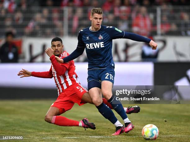 Danilho Doekhi of 1.FC Union Berlin tackles Steffen Tigges of 1.FC Koeln during the Bundesliga match between 1. FC Union Berlin and 1. FC Köln at...