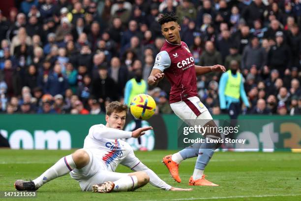 Joachim Andersen of Crystal Palace scores an own goal for Aston Villa's first goal as Ollie Watkins of Aston Villa watches on during the Premier...