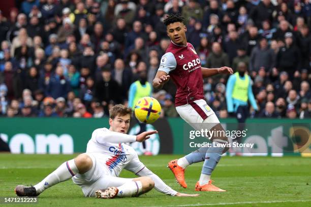 Joachim Andersen of Crystal Palace scores an own goal for Aston Villa's first goal as Ollie Watkins of Aston Villa looks on during the Premier League...