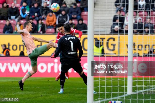 Christian Gross of SV Werder Bremen attempts to block a shot from Ruben Vargas of FC Augsberg during the Bundesliga match between FC Augsburg and SV...