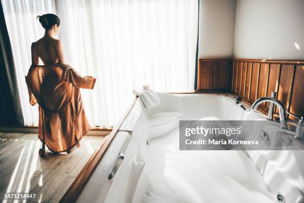 woman is relaxing in the bathroom. young woman preparing a bath. - hot tub party stock pictures, royalty-free photos & images