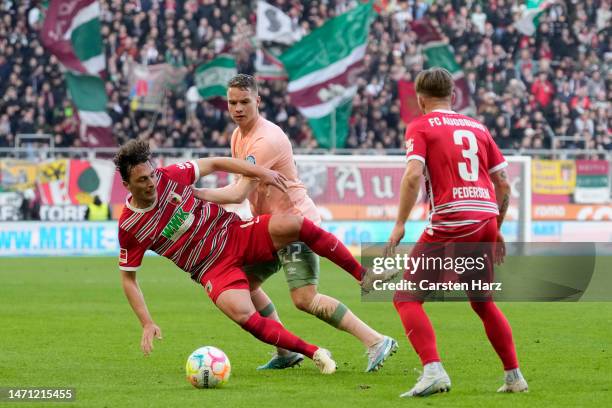 Tomas Koubek of FC Augsberg is challenged by Niklas Schmidt of SV Werder Bremen during the Bundesliga match between FC Augsburg and SV Werder Bremen...