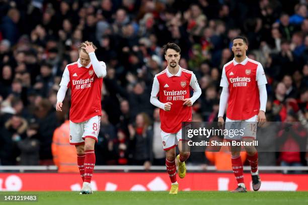 Martin Odegaard, Fabio Vieira and William Saliba of Arsenal react after AFC Bournemouth's second goal, scored by Marcos Senesi of AFC Bournemouth...