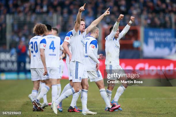 Marius Buelter of FC Schalke 04 celebrates with teammates after scoring the team's second goal during the Bundesliga match between VfL Bochum 1848...