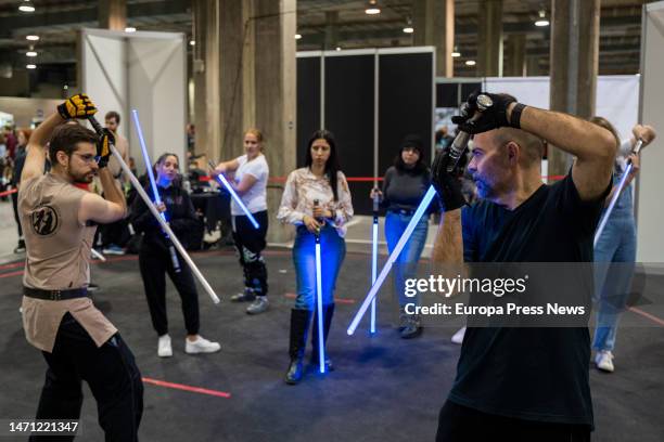 Attendees play with laser swords at the celebration of the third edition of the Salon del Comic de Valencia, on March 4 in Valencia, Valencian...