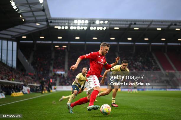 Silvan Widmer of 1.FSV Mainz 05 holds the ball whilst under pressure from Christoph Baumgartner of TSG Hoffenheim during the Bundesliga match between...