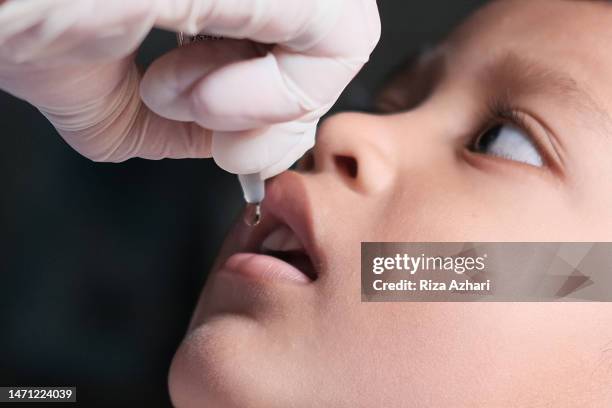 close up administering oral polio virus vaccine - polio stock pictures, royalty-free photos & images