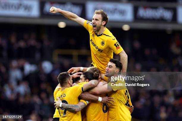 Adama Traore of Wolverhampton Wanderers celebrates with teammates after scoring the team's first goal during the Premier League match between...