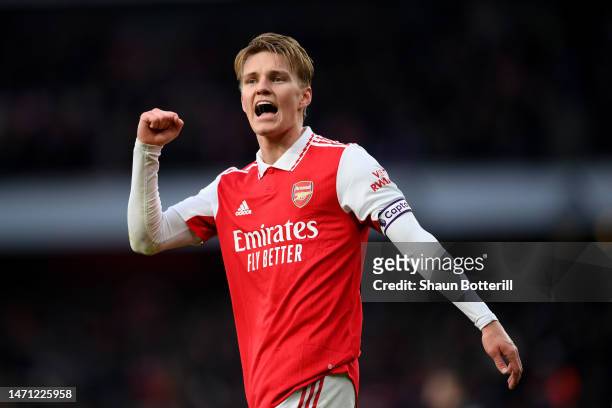 Martin Odegaard of Arsenal celebrates the team's third goal, scored by teammate Reiss Nelson during the Premier League match between Arsenal FC and...