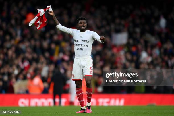 Thomas Partey of Arsenal celebrates victory whilst wearing a shirt in memory of Christian Atsu following the Premier League match between Arsenal FC...