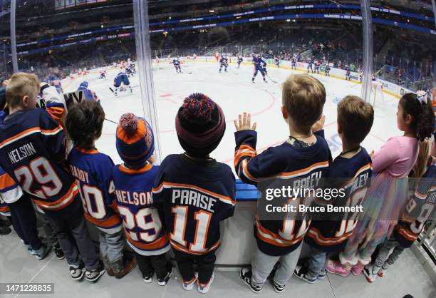 Young fans, comprised of mostly New York Islanders players children, watch warm-ups prior to the game against the Detroit Red Wings at the UBS Arena...