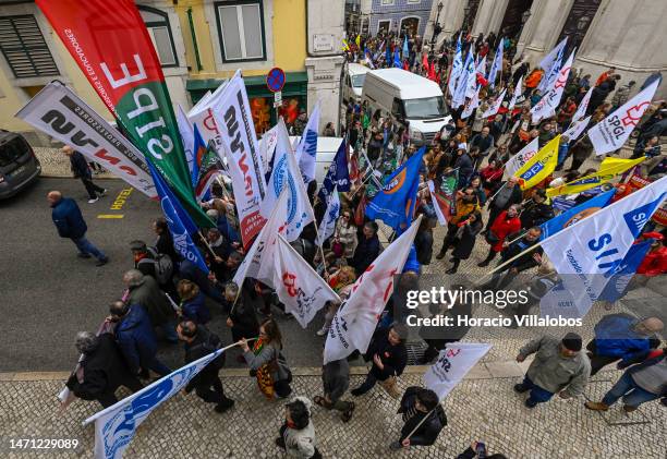 Teachers wave flags while marching for better working conditions from Rossio Square to the Portuguese Parliament during a strike called by the unions...