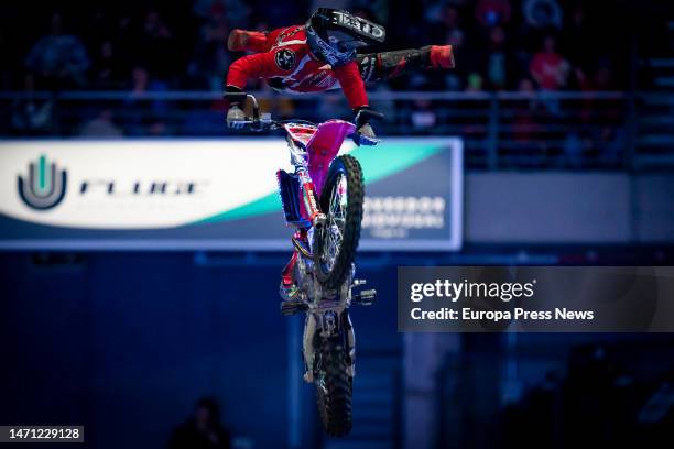 Dirt bike rider participates with a motorcycle in the Hot Wheels Monster Trucks Glow Party show that comes for the first time to the WiZink Center,...