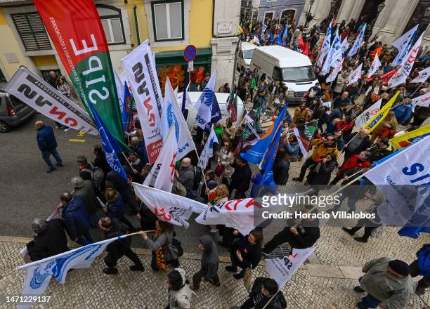 Teachers wave flags while marching for better working conditions from Rossio Square to the Portuguese Parliament during a strike called by the unions...