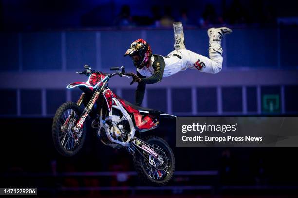 Dirt bike rider participates with a motorcycle in the Hot Wheels Monster Trucks Glow Party show that comes for the first time to the WiZink Center,...