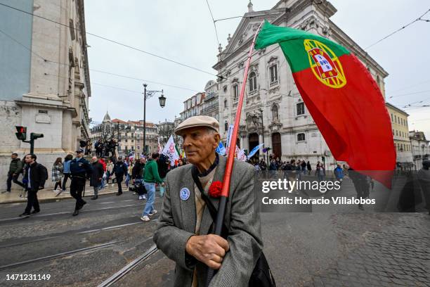 Year-old pensioner holding a Portuguese flag opens the rally as teachers protest from Rossio Square for better working conditions to the Portuguese...