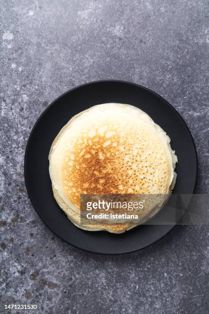 stack of fresh homemade crepes on black plate - cake from above stock pictures, royalty-free photos & images