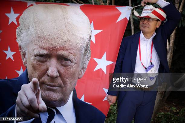 Supporter Tien Tran of San Diego, California, holds a Trump banner during the annual Conservative Political Action Conference at Gaylord National...
