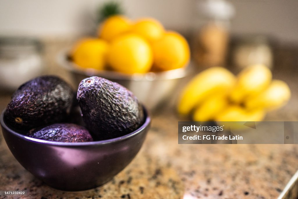 Avocados on a bowl on the kitchen counter