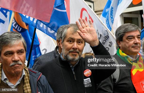 Leader Mario Nogueira walks in front row behind a banner as teachers protest for better working conditions from Rossio Square to the Portuguese...