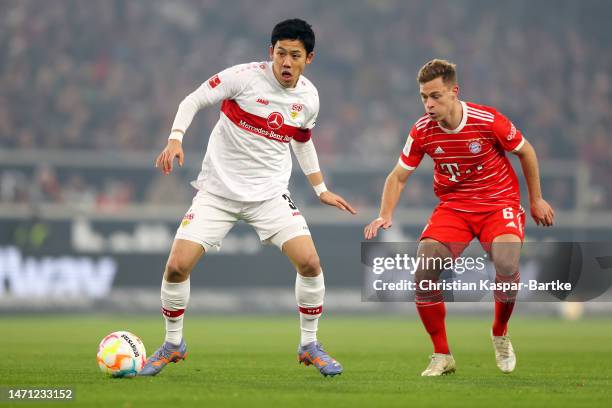 Wataru Endo of VfB Stuttgart is put under pressure by Joshua Kimmich of FC Bayern Munich during the Bundesliga match between VfB Stuttgart and FC...