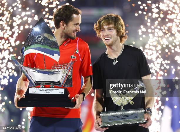 Daniil Medvedev and Andrey Rublev celebrate with their respective trophies after the Men's Final Singles match during day fourteen of the Dubai Duty...