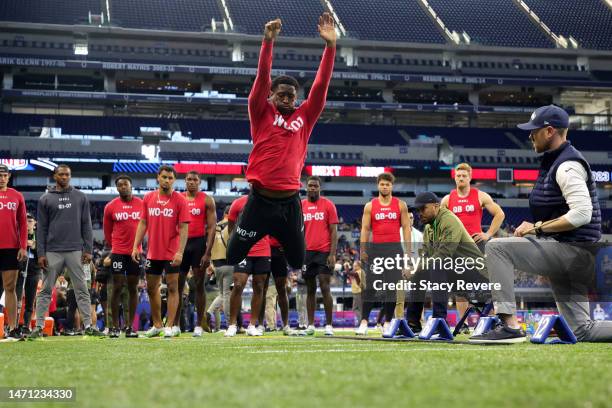 Wide receiver Jordan Addison of Southern California participates in the broad jump during the NFL Combine at Lucas Oil Stadium on March 04, 2023 in...
