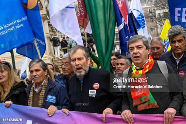 Leader Mario Nogueira chants while walking in front row behind a banner as teachers protest for better working conditions from Rossio Square to the...
