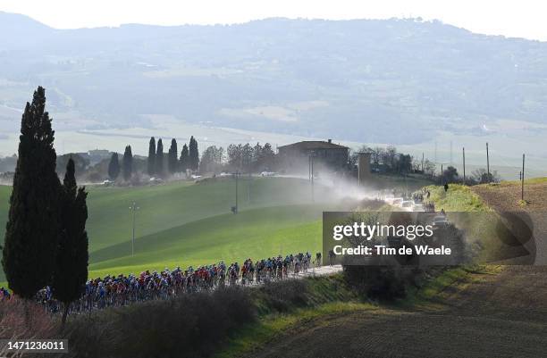 General view of the peloton passing through dusty roads at Asciano Village during the Eroica - 17th Strade Bianche 2023, Men's Elite a 184km one day...