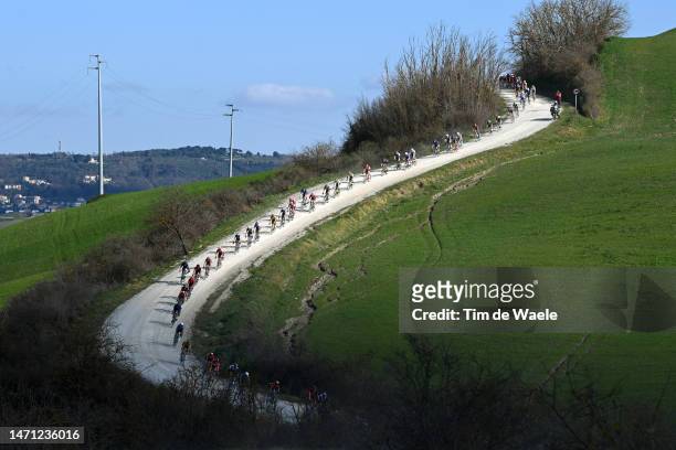 General view of the peloton passing through dusty roads at Asciano Village during the Eroica - 17th Strade Bianche 2023, Men's Elite a 184km one day...