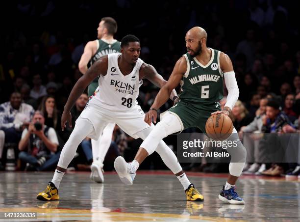 Jevon Carter of the Milwaukee Bucks in action against Dorian Finney-Smith of the Brooklyn Nets during their game at Barclays Center on February 28,...