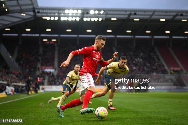 Silvan Widmer of 1.FSV Mainz 05 holds the ball whilst under pressure from Christoph Baumgartner of TSG Hoffenheim during the Bundesliga match between...