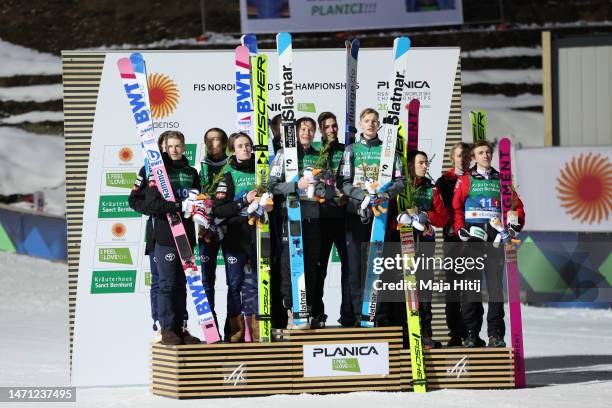 Silver medalists Team Norway, gold medalists Team Norway and bronze medalists Team Austria pose for a photo during the victory ceremony for Ski...