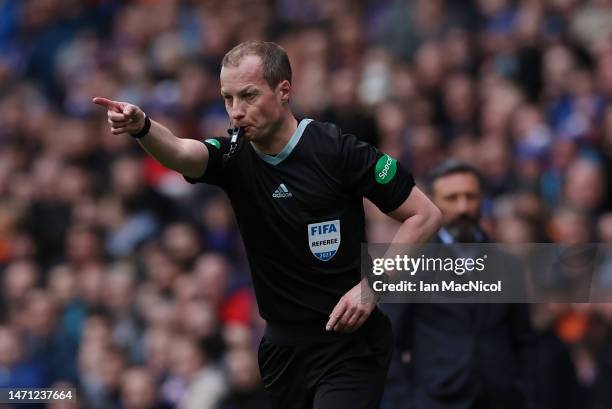 Referee Willie Collum consults VAR before awarding Rangers a penalty during the Cinch Scottish Premiership match between Rangers FC and Kilmarnock FC...