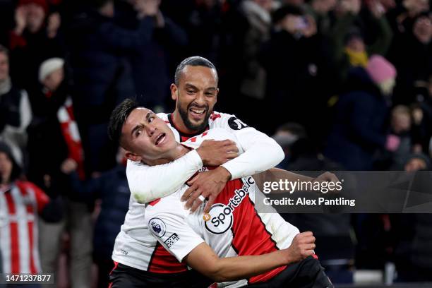 Carlos Alcaraz of Southampton celebrates after teammate Theo Walcott after scoring the team's first goal during the Premier League match between...