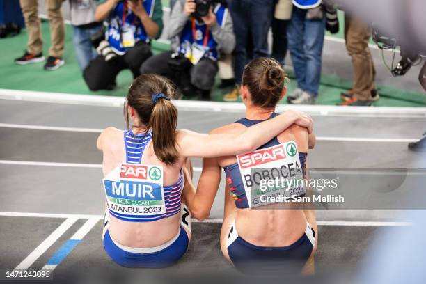 Laura Muir of Great Britain rests with Claudia Mihaela Bobocea of Romania following the Womens 1500m Final during the European Athletics Indoor...