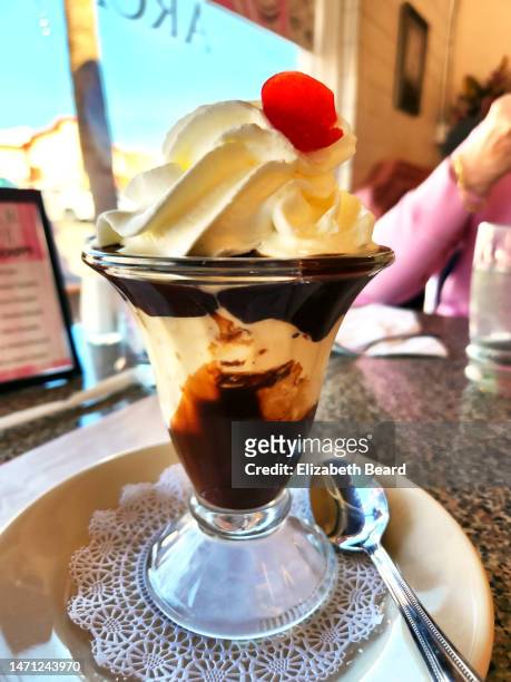 hot fudge sundae at ice cream parlor - ice cream shop stock pictures, royalty-free photos & images