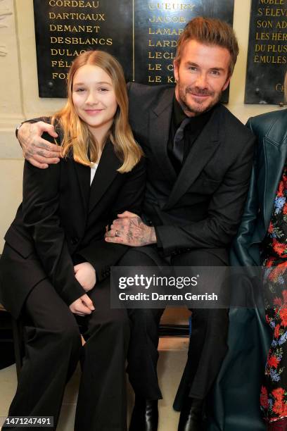 Harper Beckham and David Beckham attend the Victoria Beckham FW23 show during Paris fashion week on March 03, 2023 in Paris, France.