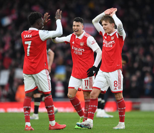 Bukayo Saka, Gabriel Martinelli and Martin Odegaard of Arsenal celebrate after the Premier League match between Arsenal FC and AFC Bournemouth at...