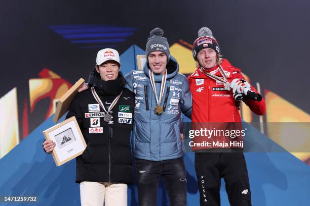 Silver medalist Ryoyu Kobayashi of Japan, gold medalist Timi Zajc of Slovenia and bronze medalist Dawid Kubacki of Poland pose for a photo during the...