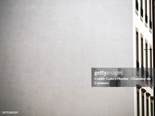 close-up of white gable and facade with windows of a residential building in geneva, switzerland - wandmalerei stock-fotos und bilder