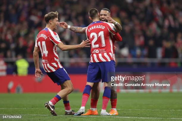 Memphis Depay of Atletico de Madrid celebrates scoring their second goal with teammates Yannick Carrasco and Marcos Llorente during the LaLiga...