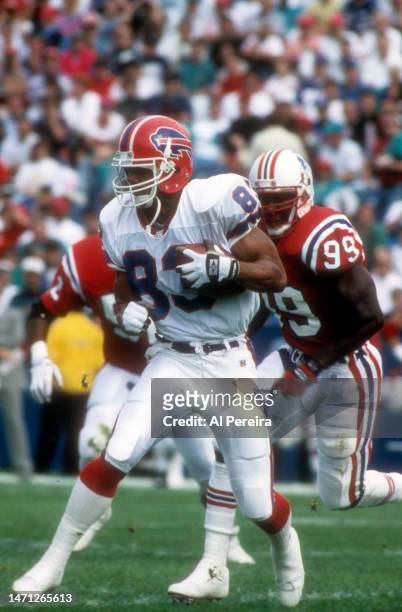 Wide Receiver Andre Reed of the Buffalo Bills makes a tough catch for a first down in the game between the Buffalo Bills vs the New England Patriots...
