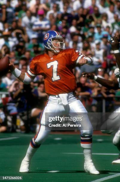 Quarterback John Elway of the Denver Broncos passes the ball in the game between the Denver Broncos vs the Philadelphia Eagles at Veterans Stadium on...