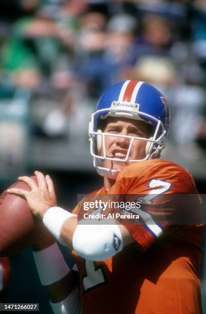 Quarterback John Elway of the Denver Broncos passes the ball in the game between the Denver Broncos vs the Philadelphia Eagles at Veterans Stadium on...